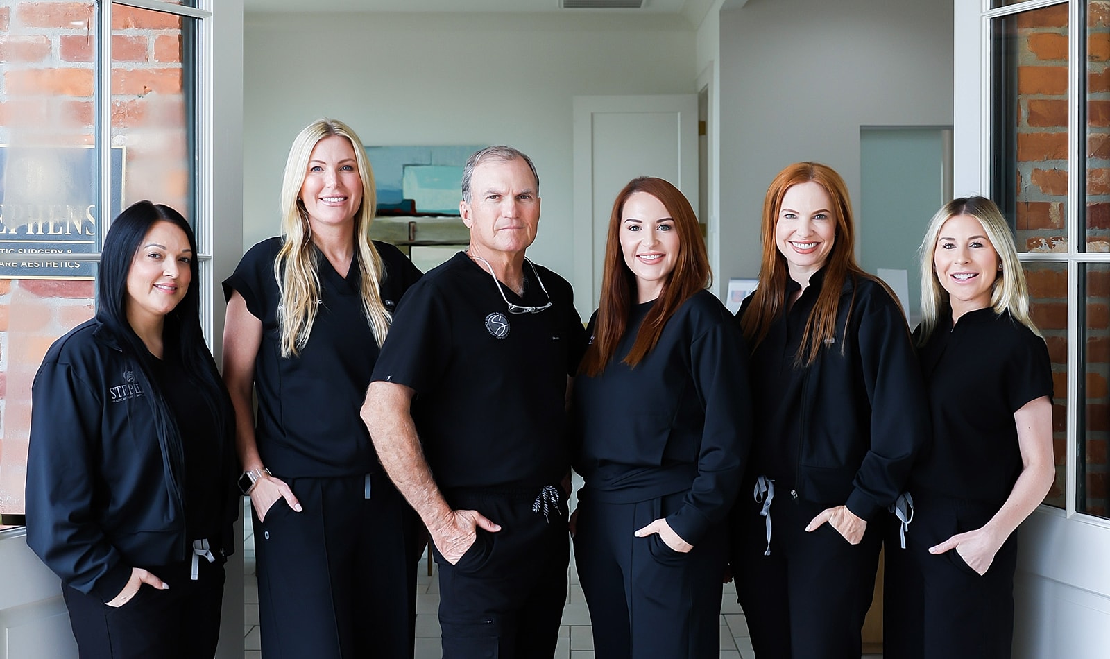 Medical team posing in professional attire.