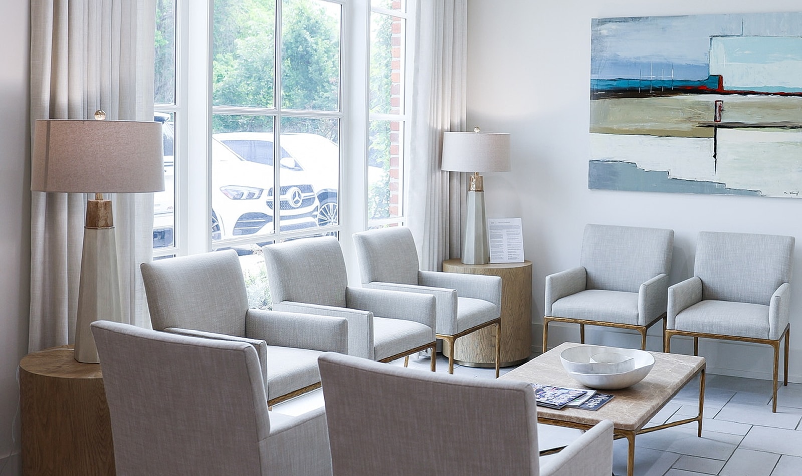 Modern seating area with lamps and artwork.