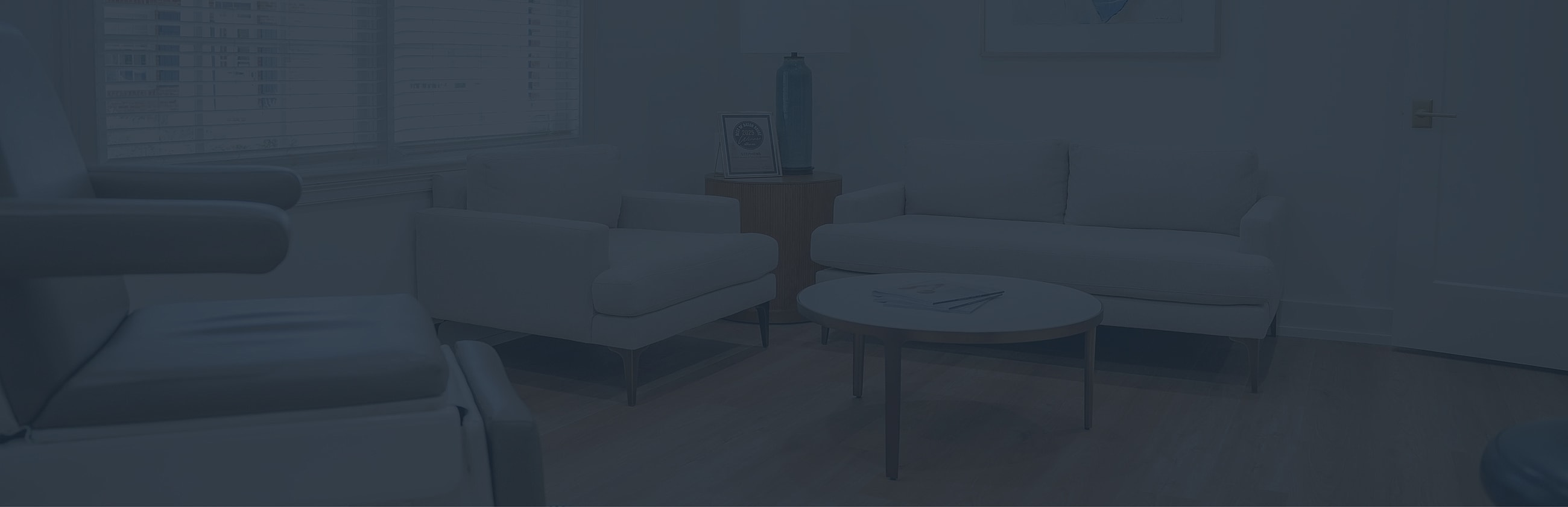 Modern, cozy waiting area with light furniture.