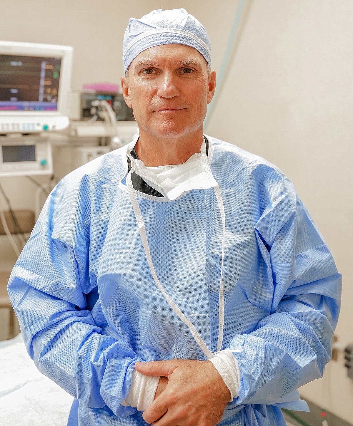 Surgeon in surgical attire, ready for procedure.