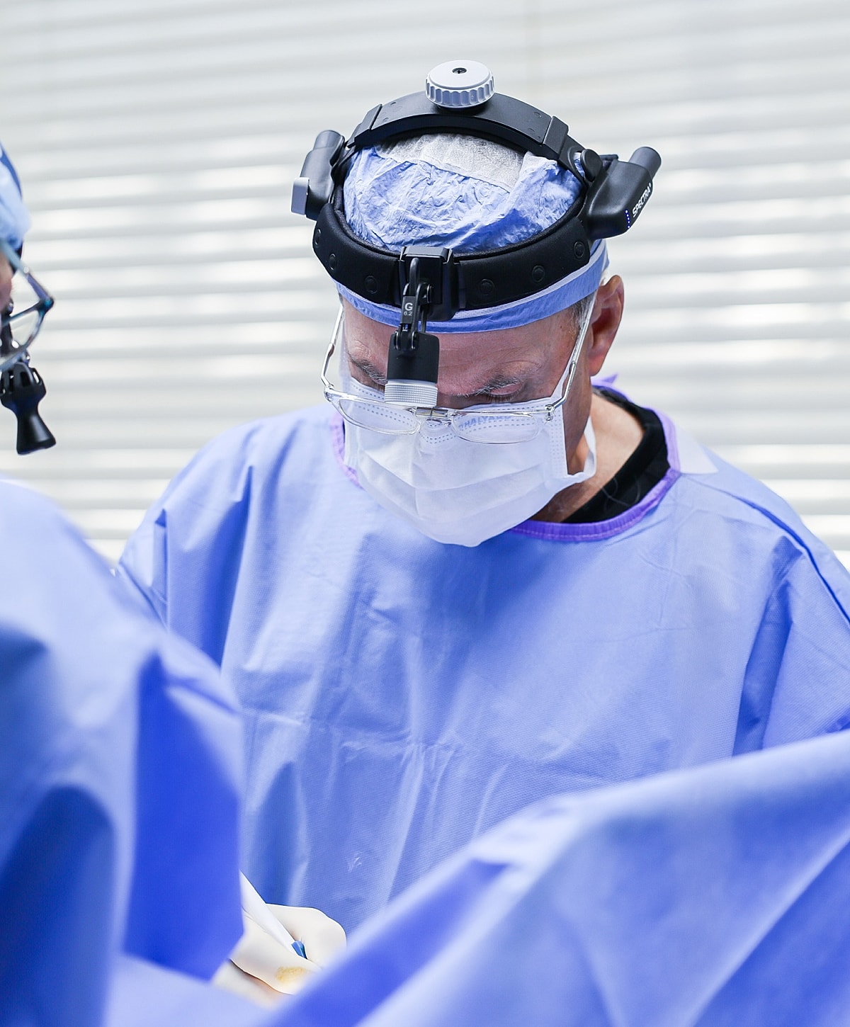 Surgeon performing surgery in an operating room.
