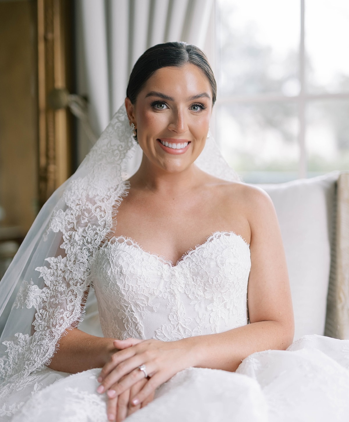 Bride in elegant wedding dress and veil.