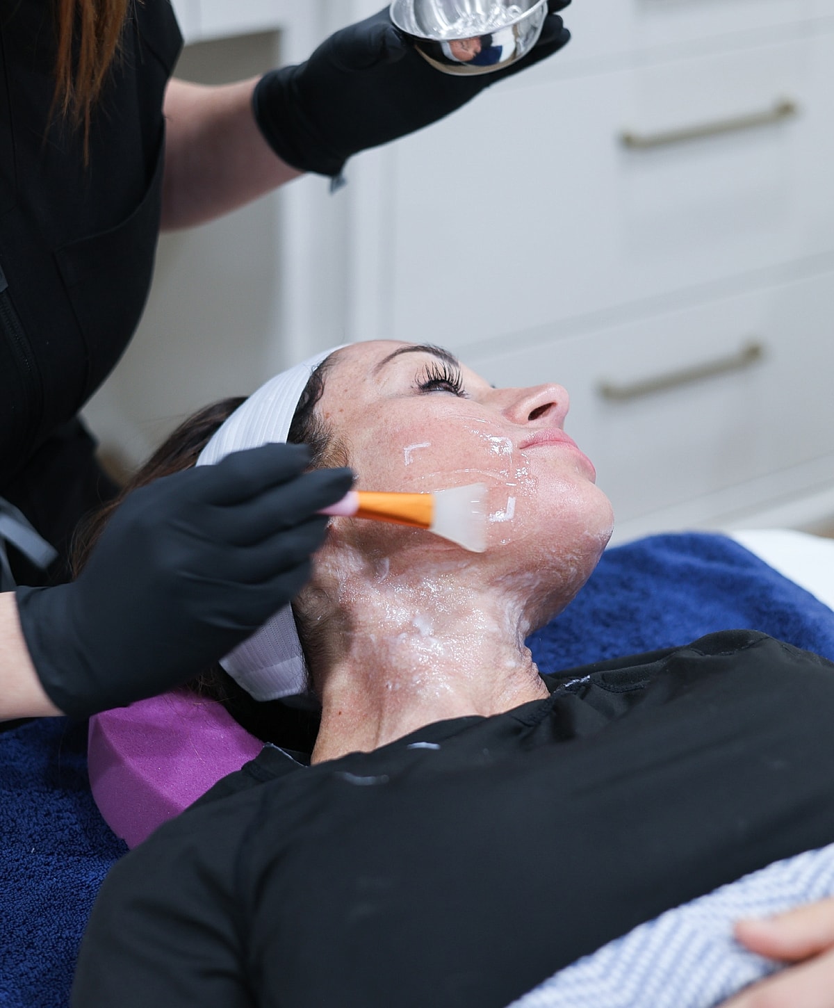 Woman receiving a facial treatment in spa.
