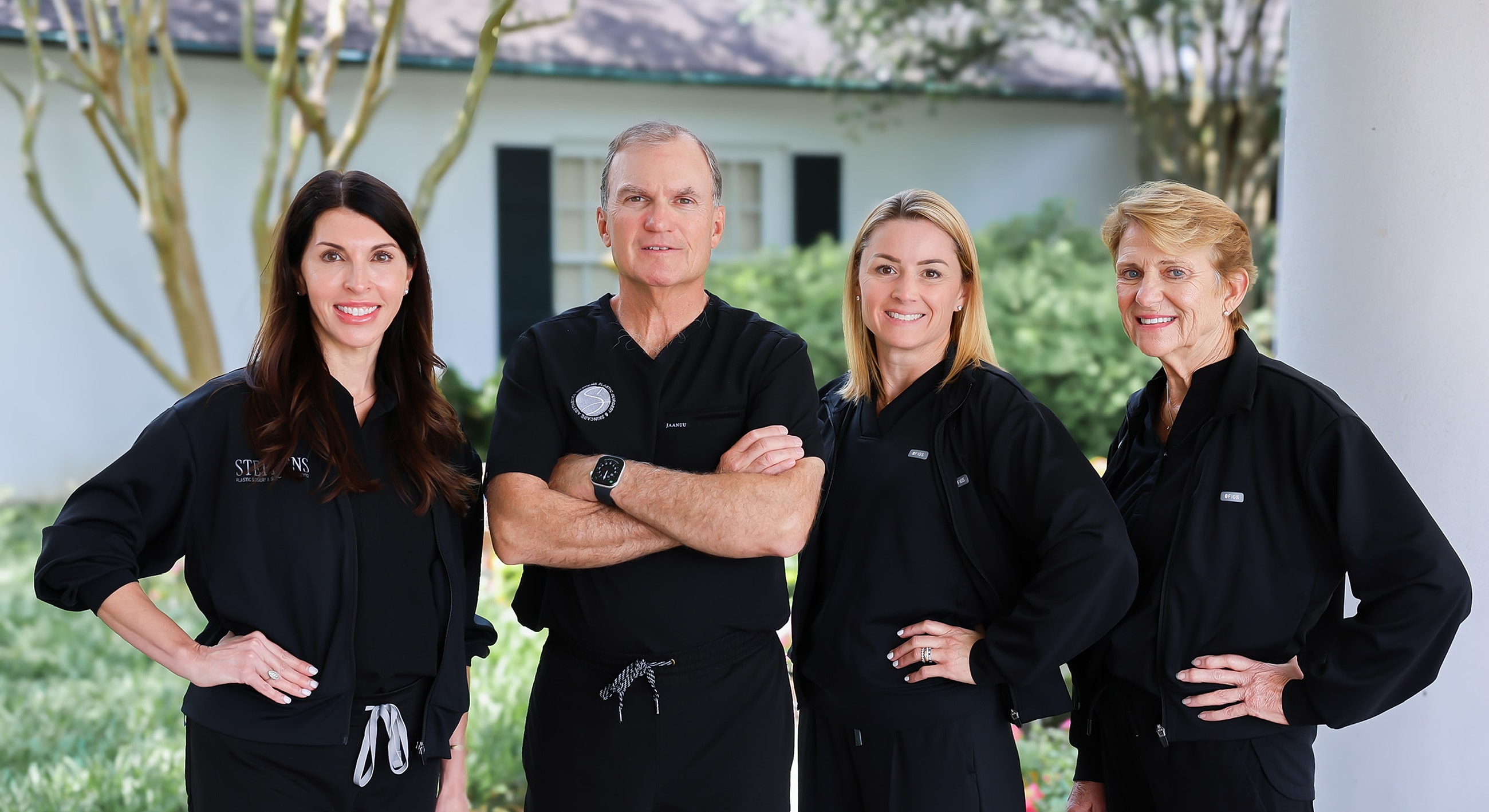 Medical professionals smiling in a clinic setting.