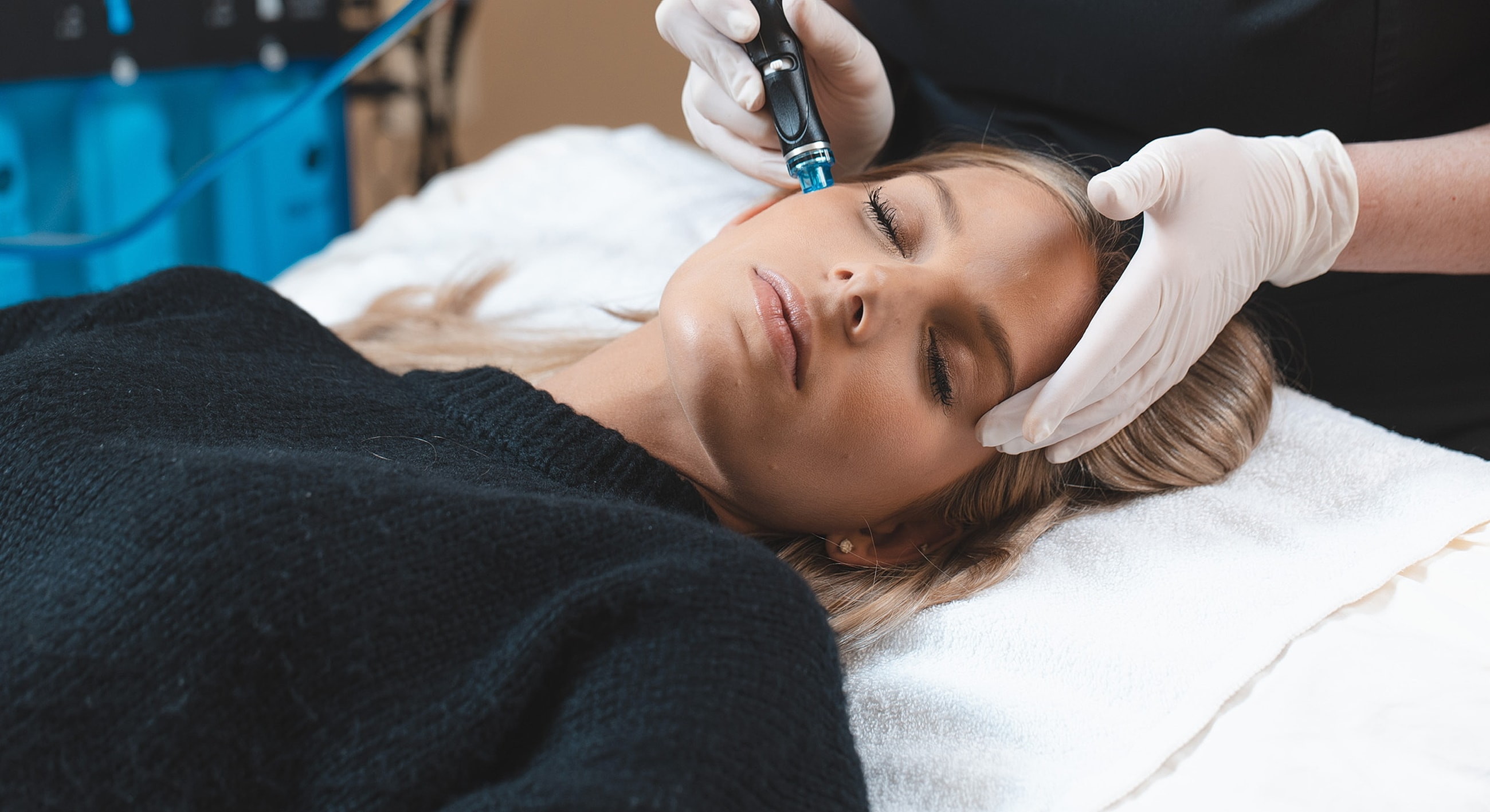 Woman receiving facial treatment in medical setting.